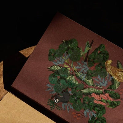 Cahier de notes en papier recyclé pour écrire avec sous-couverture motif jungle sur fond terracotta.